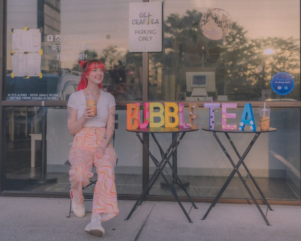 picture of artist noel with hand painted bubble tea letters